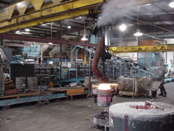 Worker Moving Metal To Pouring Platform | Midland MFG Co.